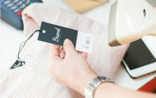 A store clerk scans a price tag with a barcode